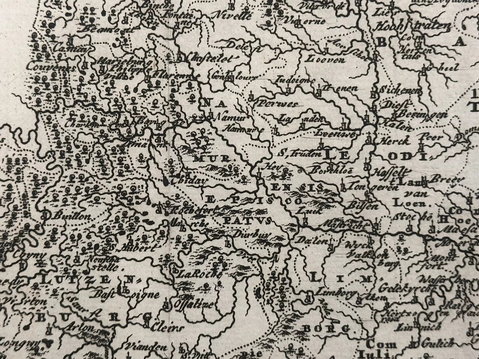 The product is an original antique map of modern Belgium or Lower Germany, dated 1697. It is a physical map printed using a copper plate technique by cartographer Philippi Cluveri. The map features a decorative antique cartouche and is from the 19th century.

Hodiernae Belgicae sive Germaniae Inferioris

Philippi Cluveri's "Introductionis in universam geographiam.. 1697

approx. 11.25 x 9 inches

copperplate engraving with hand coloring

Excellent condition: vertical folds as issued, penciled date at bottom